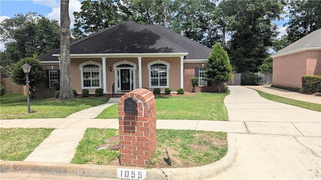 1055 Southern Way, Mobile, AL 36609 - view of front of house with covered porch, a shingled roof, and stucco siding