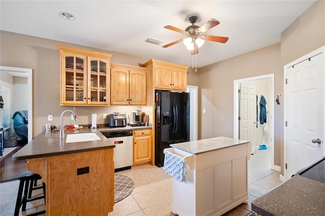 kitchen with ceiling fan, white dishwasher, black refrigerator with ice dispenser, and a center island