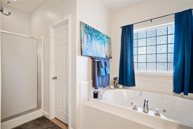 bathroom with a healthy amount of sunlight and independent shower and bath