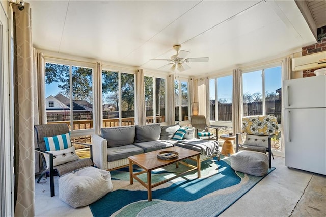 sunroom / solarium featuring ceiling fan, a wall unit AC, and a healthy amount of sunlight