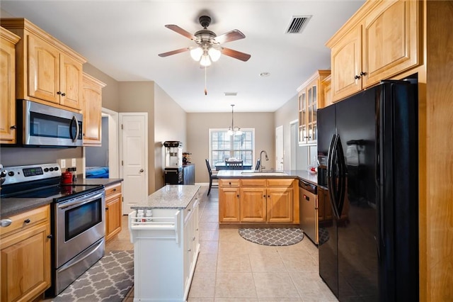 kitchen featuring light tile floors, stainless steel appliances, sink, ceiling fan, and decorative light fixtures