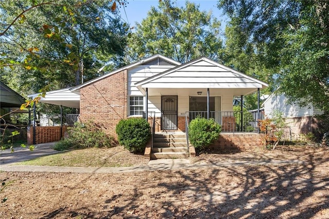 4010 Cresthaven Rd, Mobile, AL 36609 - bungalow-style home with brick siding, an attached carport, a porch, and driveway