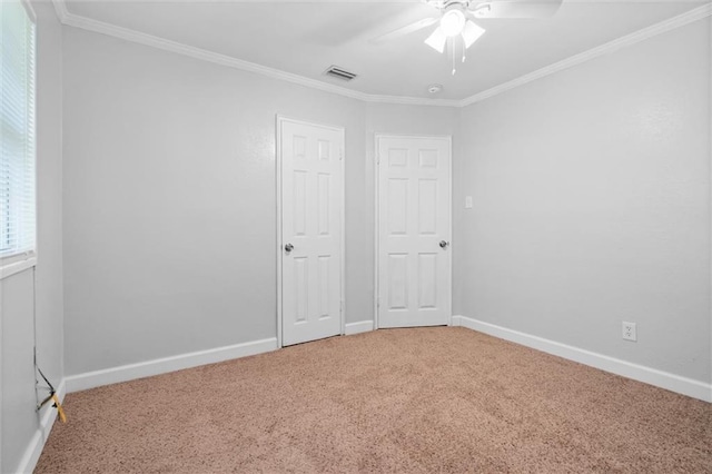 unfurnished bedroom with ceiling fan, ornamental molding, and carpet floors