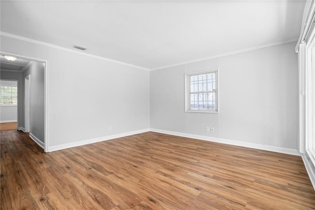 spare room featuring ornamental molding and wood-type flooring