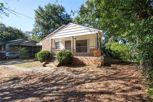 bungalow-style house featuring a carport and a porch