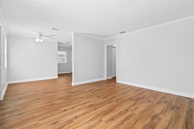 unfurnished room featuring ornamental molding, light wood-type flooring, and ceiling fan