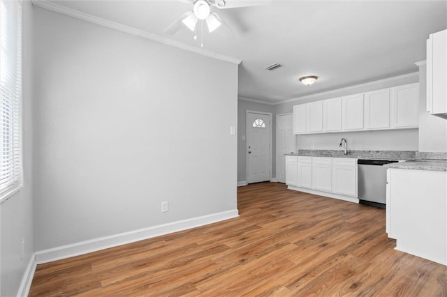 kitchen with ornamental molding, stainless steel dishwasher, white cabinets, light hardwood / wood-style floors, and ceiling fan