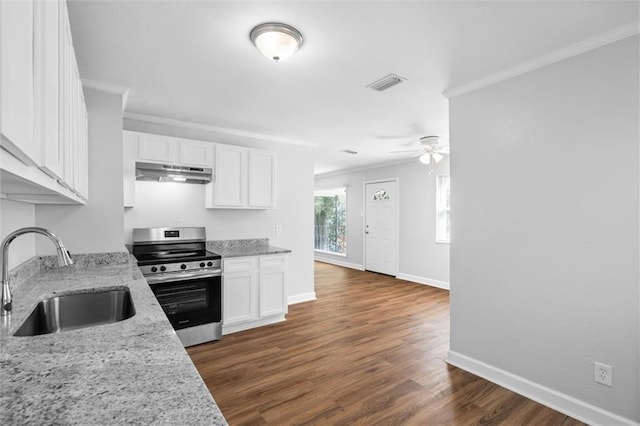 kitchen with stainless steel range, sink, light stone countertops, white cabinets, and dark hardwood / wood-style flooring