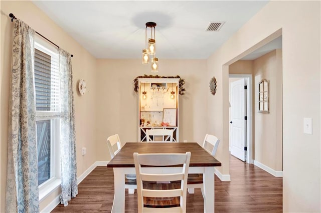 dining space with dark hardwood / wood-style floors