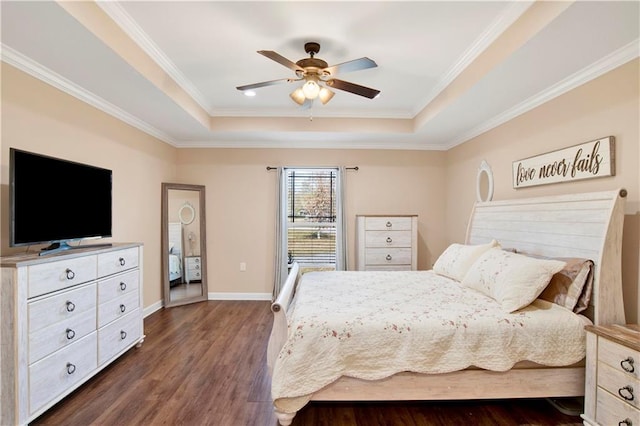 bedroom featuring ceiling fan, dark hardwood / wood-style flooring, a raised ceiling, and ornamental molding