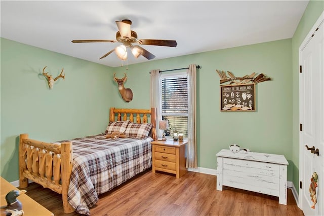 bedroom with ceiling fan, a closet, and light hardwood / wood-style flooring