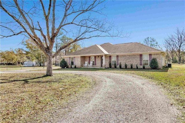 single story home featuring a front lawn