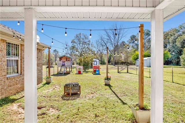 view of yard with a playground and an outdoor fire pit