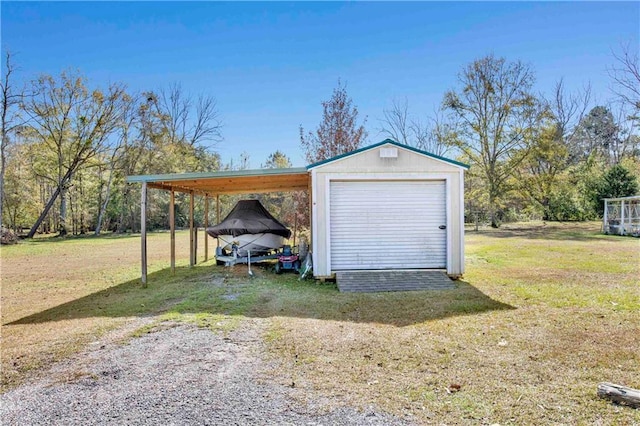 garage featuring a carport and a lawn