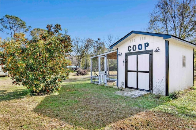 view of outbuilding featuring a yard