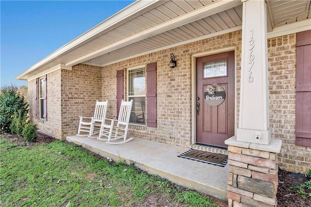 view of exterior entry with a porch