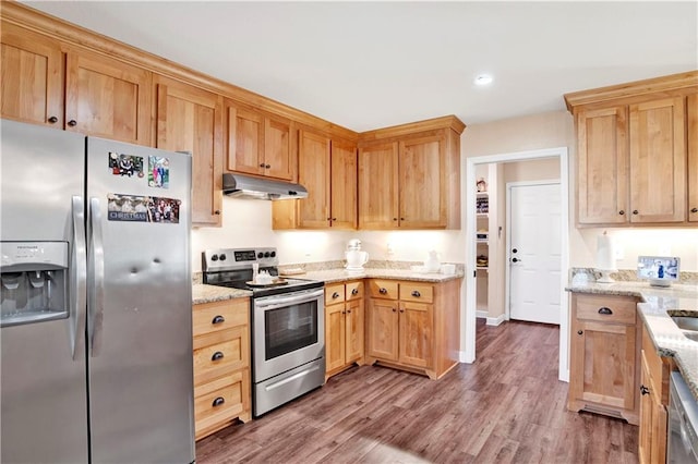 kitchen featuring dark hardwood / wood-style flooring, light stone countertops, and stainless steel appliances