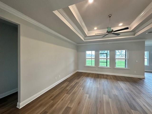 spare room featuring ornamental molding, ceiling fan with notable chandelier, and hardwood / wood-style flooring