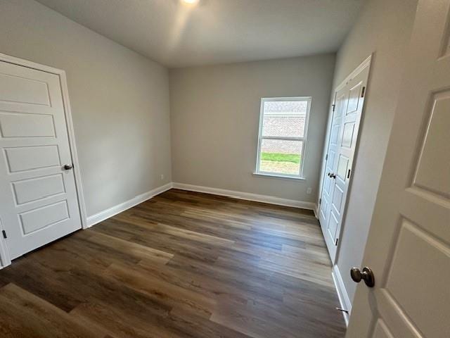 kitchen with white cabinets, an inviting chandelier, light stone countertops, stainless steel appliances, and light hardwood / wood-style floors