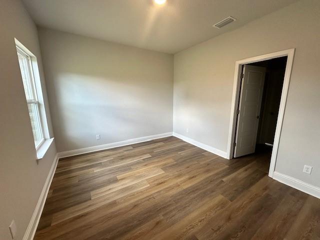 spare room with dark hardwood / wood-style floors