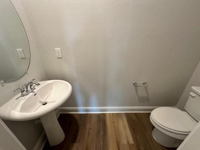 bathroom featuring toilet and hardwood / wood-style flooring