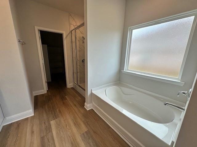 bathroom featuring hardwood / wood-style floors and shower with separate bathtub