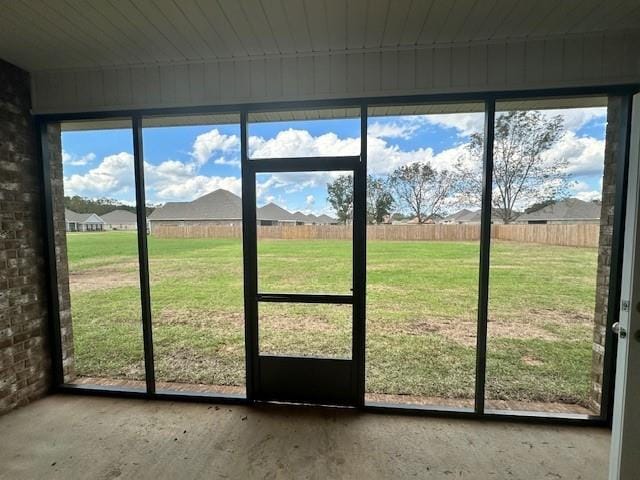 doorway featuring a healthy amount of sunlight and concrete flooring