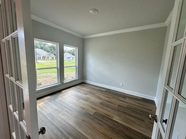 empty room with a healthy amount of sunlight, ornamental molding, and light wood-type flooring