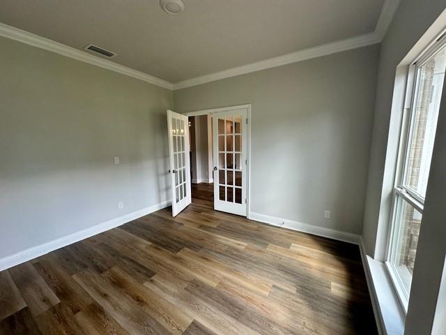 spare room with ceiling fan with notable chandelier, crown molding, and plenty of natural light