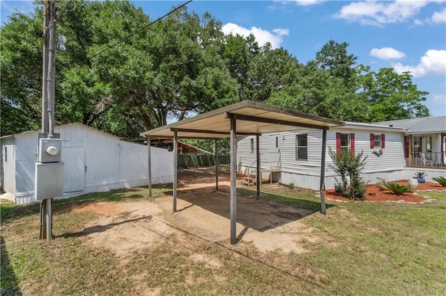 3628 Jarvis Ln, Semmes, AL 36575 - view of patio / terrace with a detached carport, dirt driveway, and an outbuilding