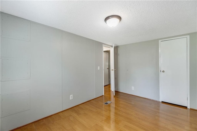 3628 Jarvis Ln, Semmes, AL 36575 - unfurnished bedroom featuring light wood-style flooring and a textured ceiling