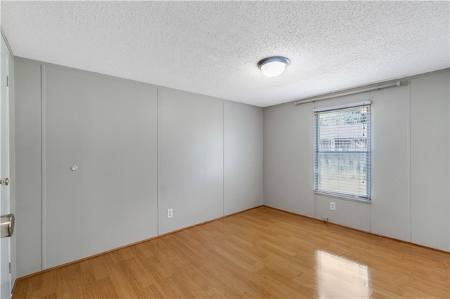 3628 Jarvis Ln, Semmes, AL 36575 - spare room with wood finished floors and a textured ceiling