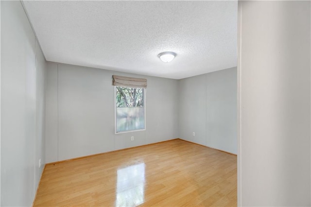 3628 Jarvis Ln, Semmes, AL 36575 - unfurnished room featuring light wood-style flooring and a textured ceiling