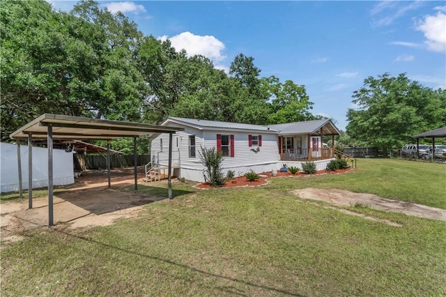 3628 Jarvis Ln, Semmes, AL 36575 - manufactured / mobile home featuring a porch, a detached carport, metal roof, and driveway
