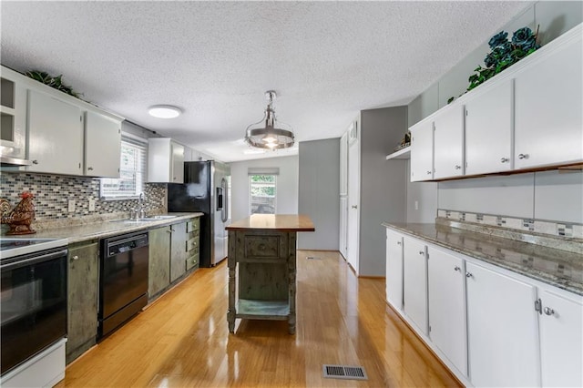 3628 Jarvis Ln, Semmes, AL 36575 - kitchen featuring black dishwasher, white electric stove, a sink, stainless steel refrigerator with ice dispenser, and plenty of natural light