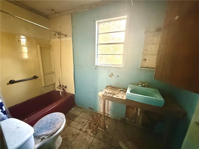 full bathroom featuring toilet,  shower combination, and sink