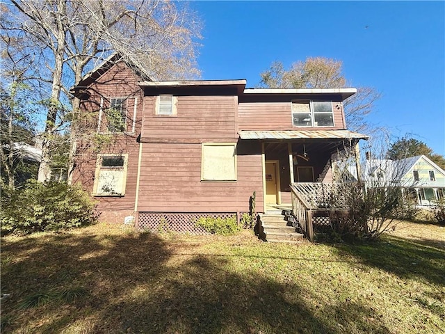 view of front of house with covered porch and a front lawn