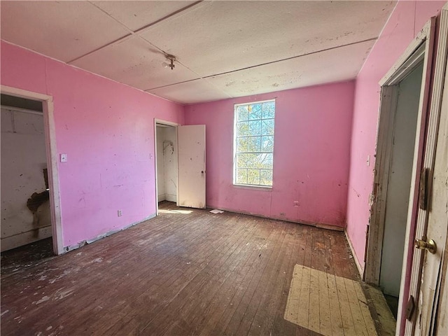 unfurnished bedroom with dark hardwood / wood-style floors