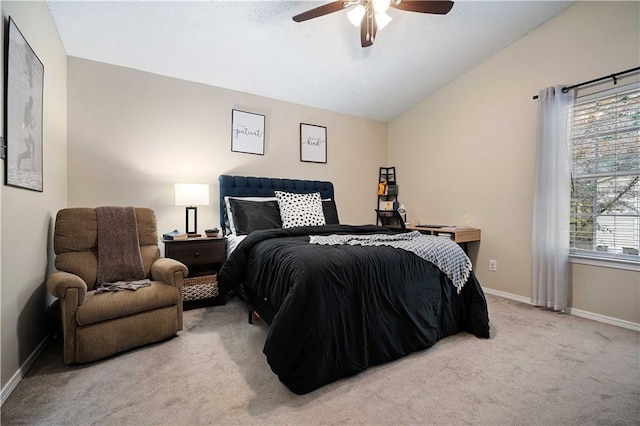 carpeted bedroom featuring vaulted ceiling, baseboards, and a ceiling fan
