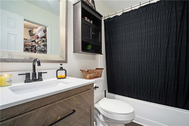 bathroom featuring toilet, vanity, and shower / bath combo with shower curtain