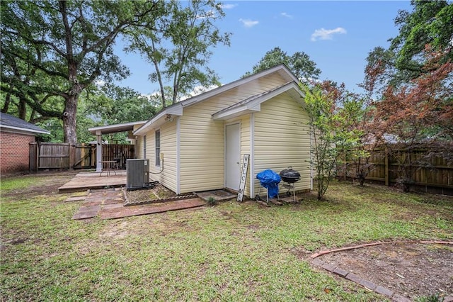 back of property featuring central air condition unit and a wooden deck