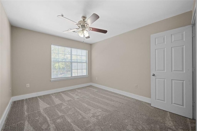 unfurnished room featuring ceiling fan and carpet