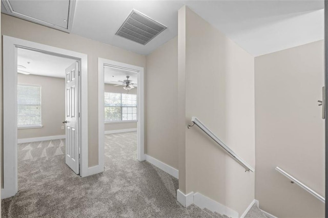 hallway with light colored carpet