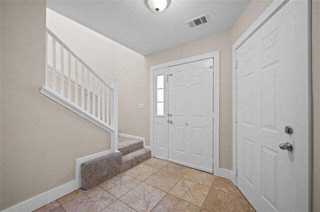 1517 Regency Rd Unit 46, Gulf Shores, AL 36542 - foyer entrance featuring stairway, baseboards, and visible vents