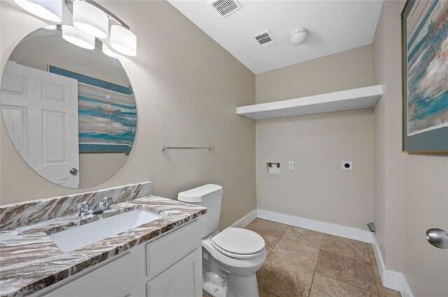1517 Regency Rd Unit 46, Gulf Shores, AL 36542 - bathroom with baseboards, toilet, vanity, and visible vents