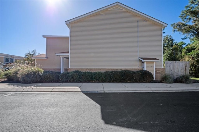 1517 Regency Rd Unit 46, Gulf Shores, AL 36542 - view of side of home with brick siding and fence