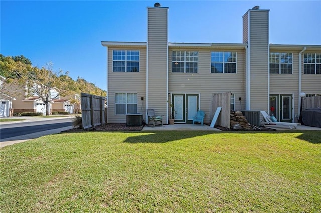 back of house with a patio, a lawn, and french doors