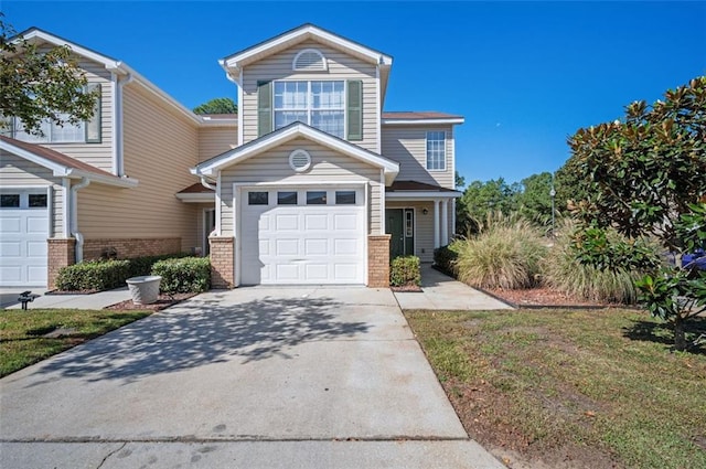 view of property featuring a front yard and a garage