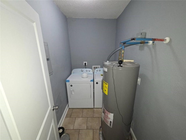 1105 Adams St, Mobile, AL 36603 - laundry area featuring water heater, washing machine and dryer, light tile patterned floors, and a textured ceiling