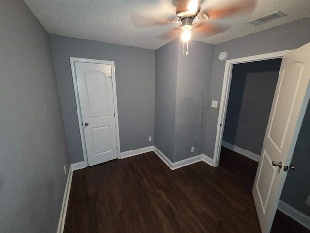 1105 Adams St, Mobile, AL 36603 - empty room featuring dark wood finished floors, a ceiling fan, a textured ceiling, and a smoke detector